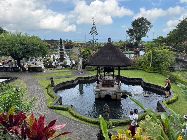 A pavilion in an ornamental pool within a landscaped Balinese temple garden