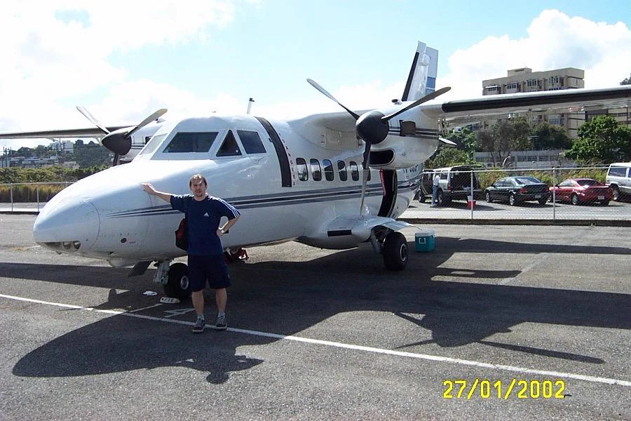 A person beside an L410 on the apron · Venezuela, personal archive, visible date stamp 27/01/2002