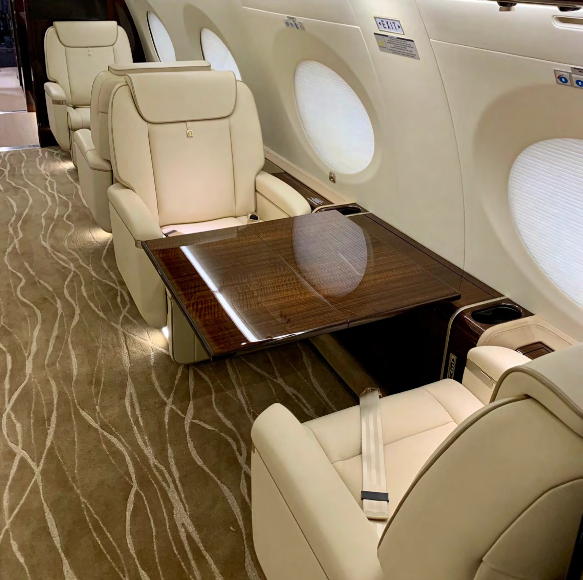 Club seats around an extended polished wood table