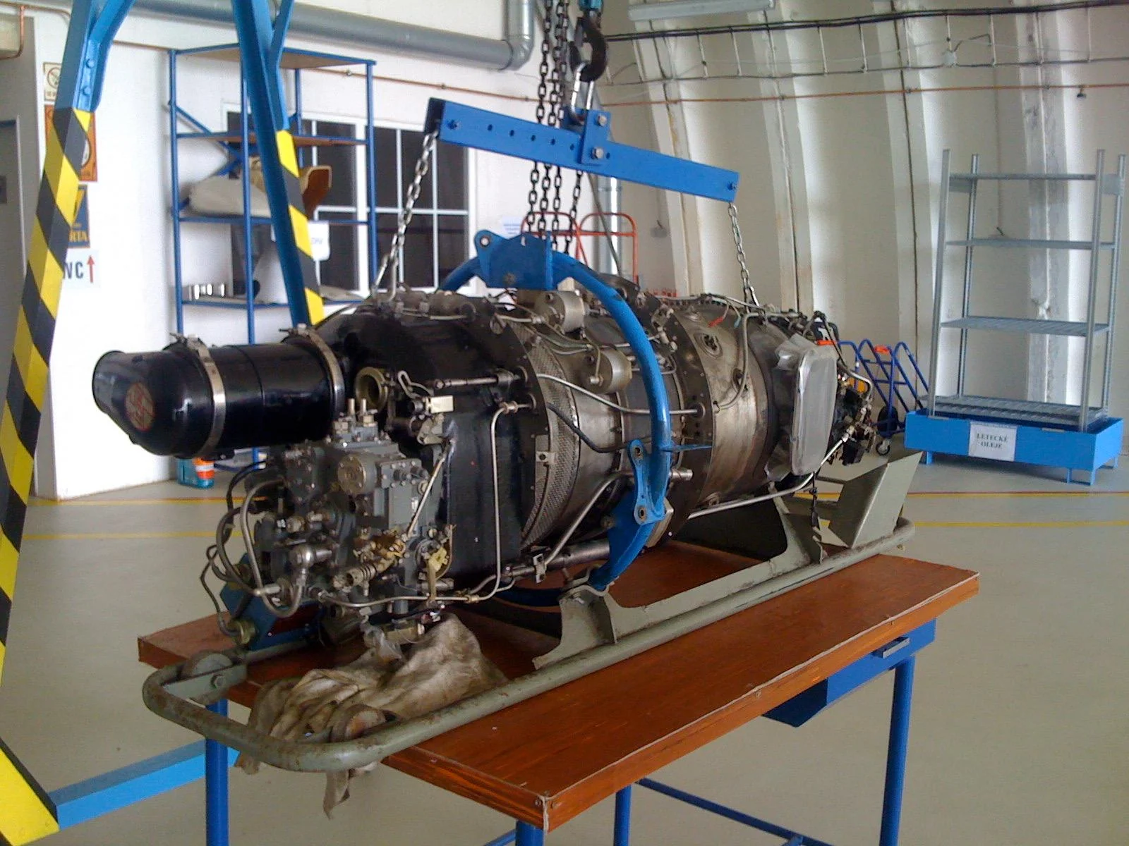 M601D engine mounted in a blue handling frame in a workshop